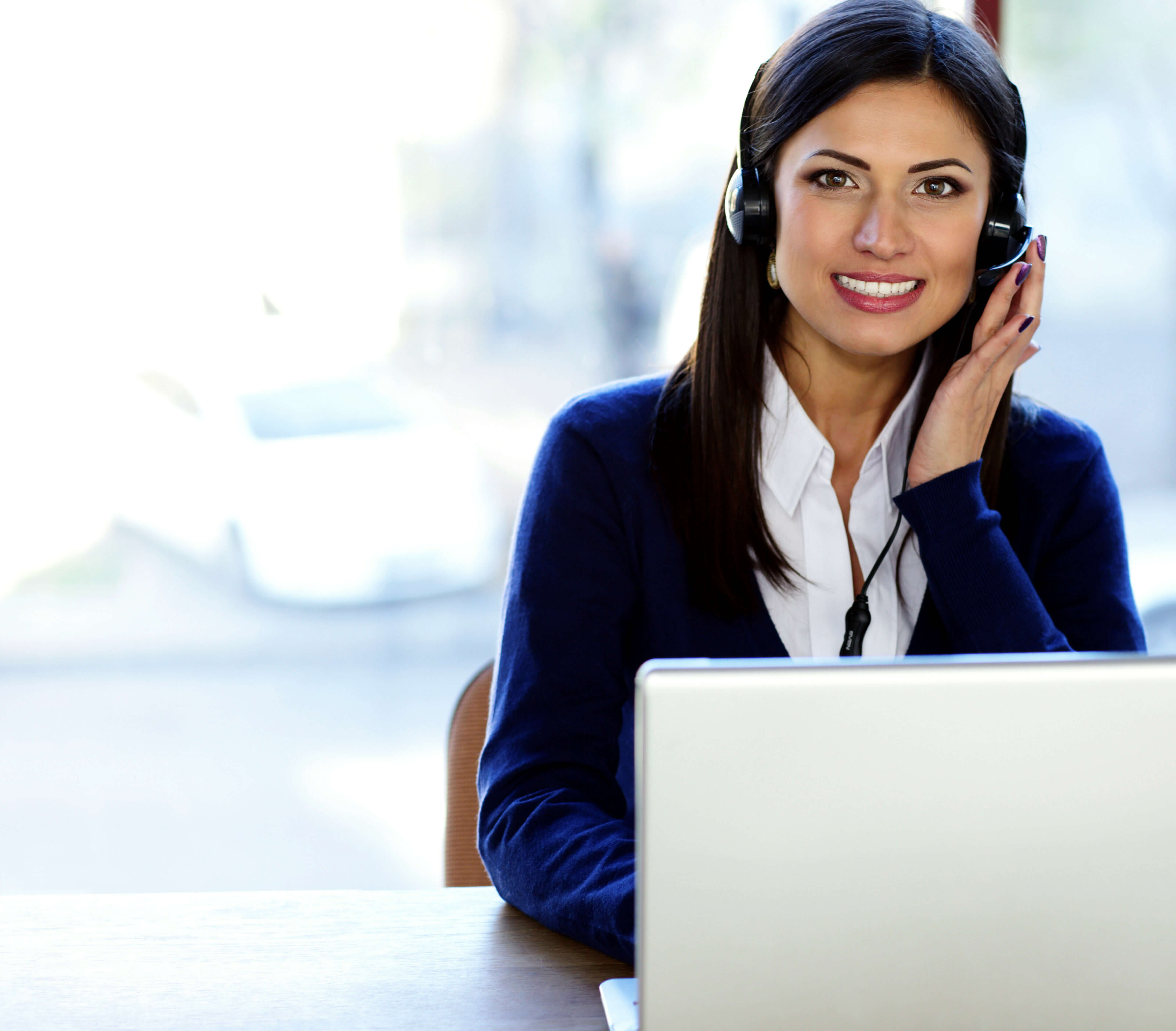 Happy beautiful call-center assistant at the desk